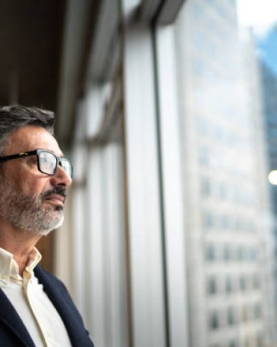 Mature businessman looking out of window